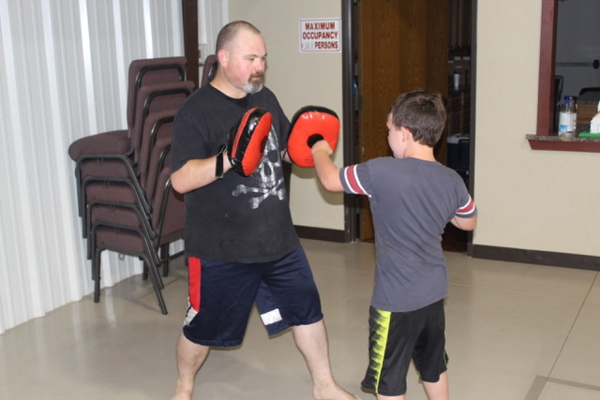 Keith Hampton works with a Warrior Journey student in June 2019.